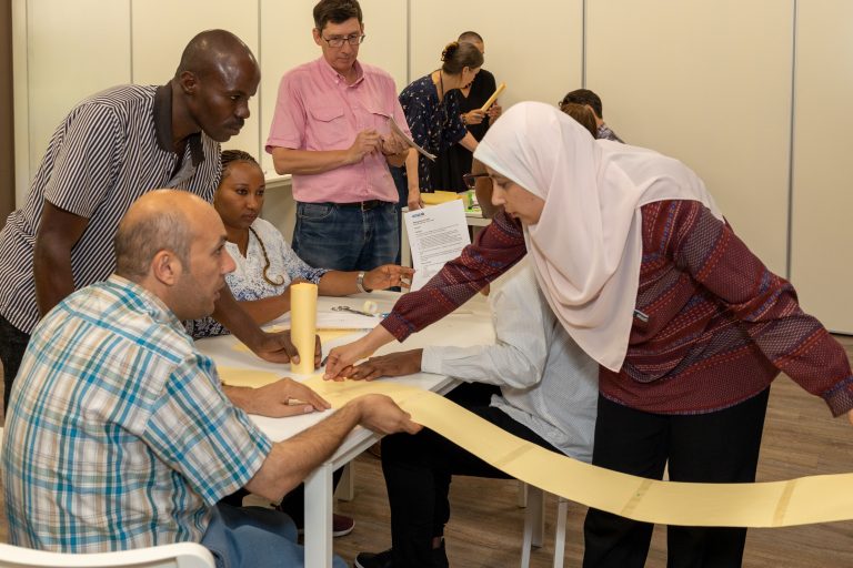 Participants engaging in an interactive training session, focused on active learning strategies