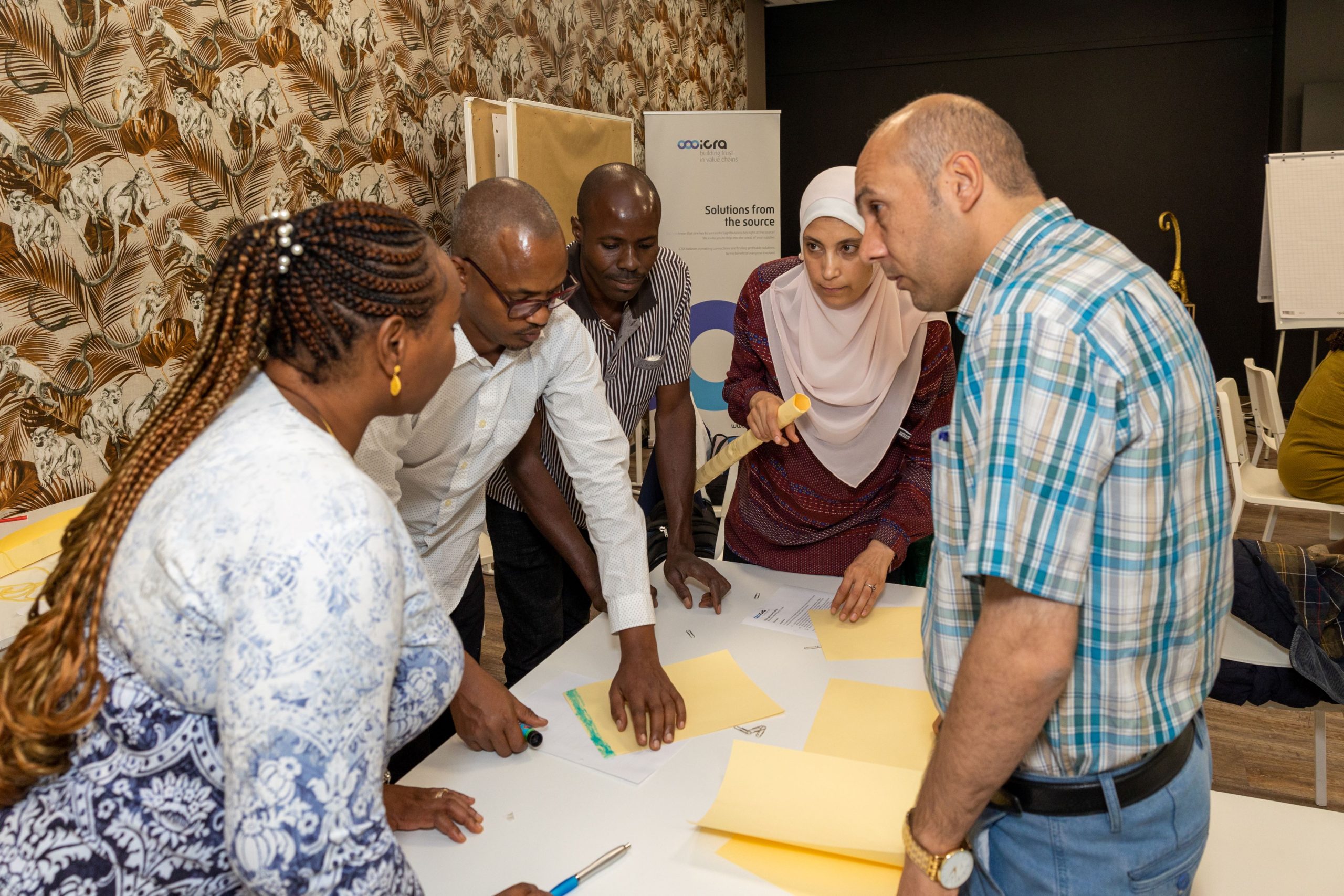 Group of participants in an iCRA postgraduate training session discussing sustainable farming techniques