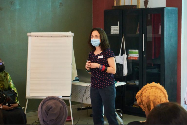 iCRA's trainer Myriam standing in front of a flipchart to deliver training in Mali