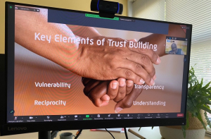 A handshake representing the foundation of trust in professional relationship in iCRA expert talk 025