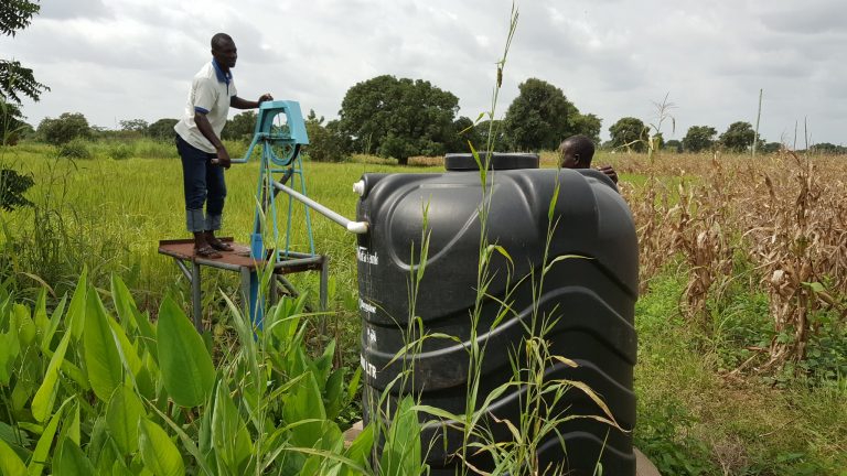 A_farmer_filling_his_watertank_for_irrigation